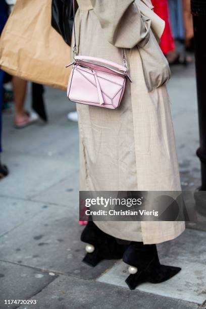 Yasmin Sewell is seen wearing grey beige two tone trench coat, pink Loewe bag outside Rejina Pyo during London Fashion Week September 2019 on...