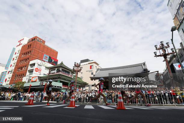 Honami Maeda, Yuka Ando, Rei Ohara, Ayuko Suzuki and Kayoko Fukushi pass the Kaminarimon at Sensoji Temple during the Marathon Grand Championships,...