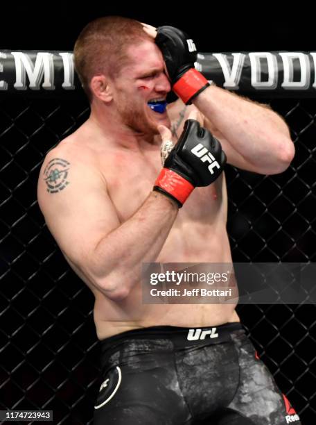 Todd Duffee reacts after suffering an eye-poke from Jeff Hughes in their heavyweight bout during the UFC Fight Night event at Rogers Arena on...