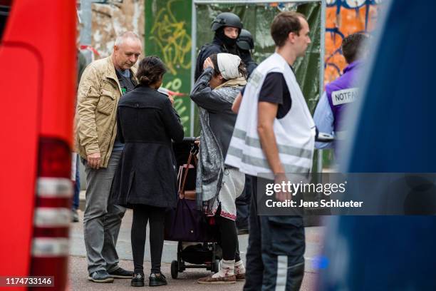 Rescued parishioners of the Jewish community and police forces near the scene of a shooting that has left two people dead on October 9, 2019 in...