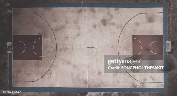 aerial shot/old basketball courts that are lonely with only one player without the team and the competition - old basketball hoop stock pictures, royalty-free photos & images