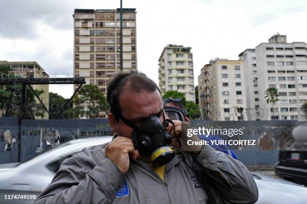 Municipal workers put masks on before fumigating against the aedes aegypti mosquito, vector of dengue fever, Zika fever and chikunguya, at El Dorado...