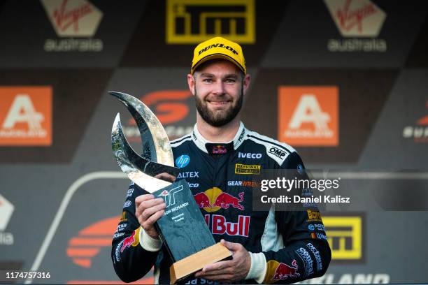 Shane van Gisbergen driver of the Red Bull Holden Racing Team Holden Commodore ZB celebrates with the Jason Richards Memorial Trophy during the...