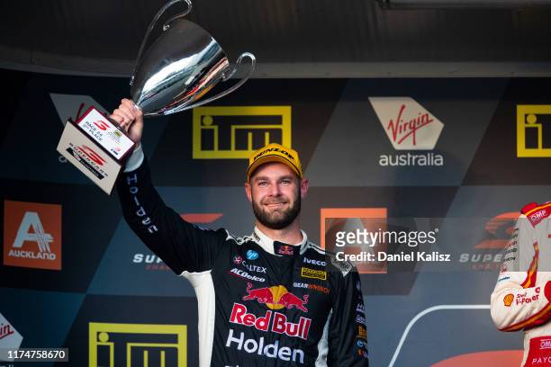 Shane van Gisbergen driver of the Red Bull Holden Racing Team Holden Commodore ZB celebrates on the podium after race 2 for the Auckland SuperSprint...
