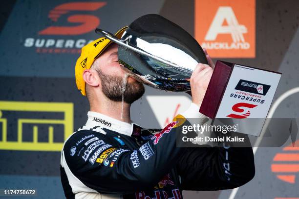 Shane van Gisbergen driver of the Red Bull Holden Racing Team Holden Commodore ZB celebrates on the podium after race 2 for the Auckland SuperSprint...