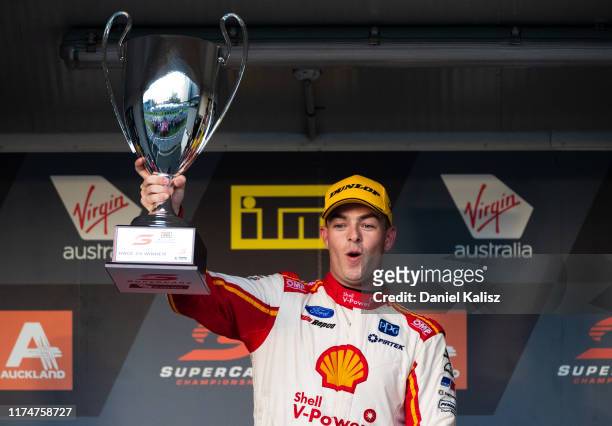 Scott McLaughlin driver of the Shell V-Power Racing Team Ford Mustang celebrates on the podium after race 2 for the Auckland SuperSprint Supercars...