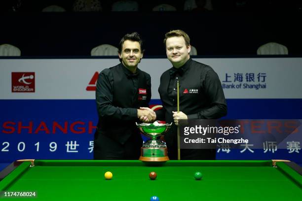 Ronnie O'Sullivan of England shakes hands with Shaun Murphy of England prior to their final match on day 7 of World Snooker Shanghai Masters 2019 at...