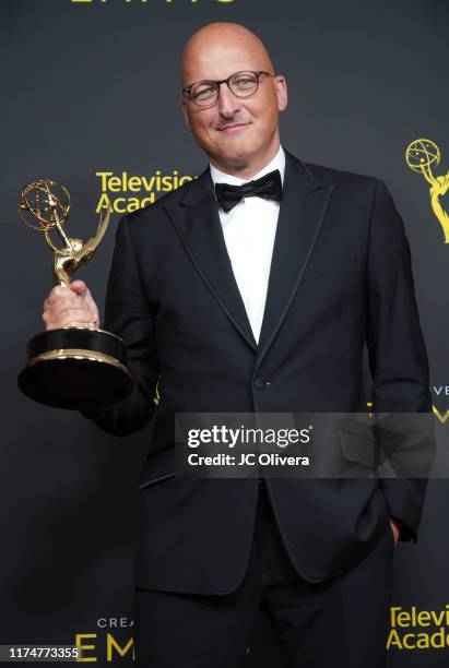 Director Dan Reed poses in the press room with the award for outstanding documentary or nonfiction special for Leaving Neverland' during the 2019...