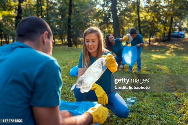 local community service cleanup - volunteers cleaning public park stock pictures, royalty-free photos & images