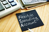 Flexible spending account FSA sign on a black piece of paper.