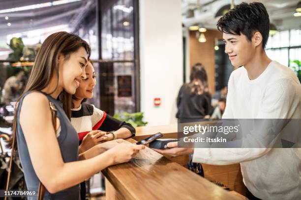 cardless paying at the reception. - asian credit card imagens e fotografias de stock