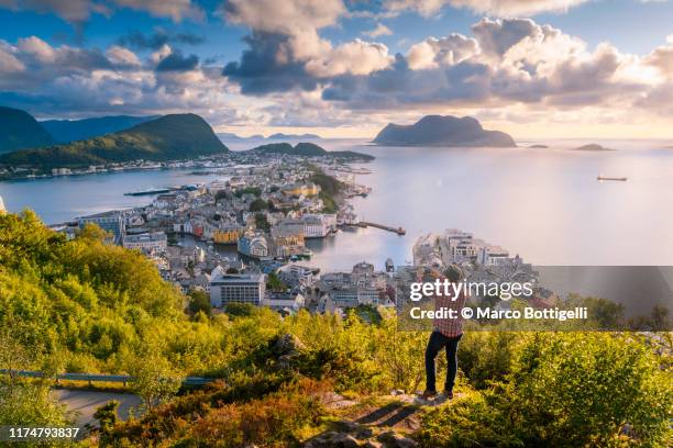 tourist taking pictures of alesund at sunset, norway - alesund stock pictures, royalty-free photos & images