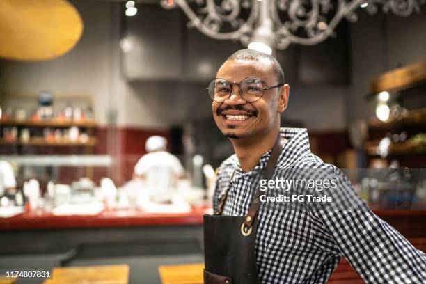 portrait of waiter at pizzeria - black cook stock pictures, royalty-free photos & images