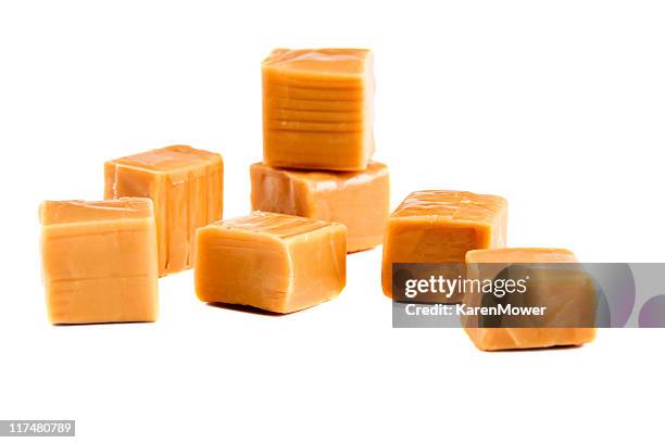 unwrapped caramel candies on a white background - karamellsås bildbanksfoton och bilder