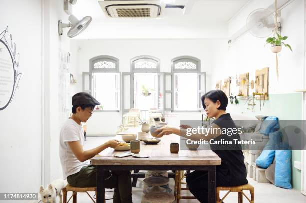 colleagues eating lunch in their work studio - eating laksa stock pictures, royalty-free photos & images