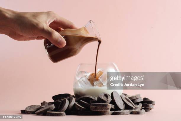 pouring chocolate syrup in glass - syrup stock pictures, royalty-free photos & images