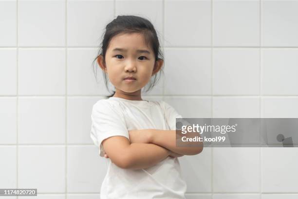 cute little girl portrait - girl arms crossed stock pictures, royalty-free photos & images