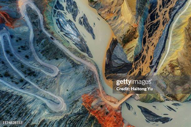 mining truck driving down winding dirt road to the bottom of a canyon - china abstract photos et images de collection