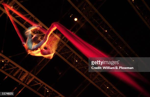 Aerial artist Isabelle Vaudelle hangs in a column of red silk during a dress rehearsal of Cirque du Soleil's show "Quidam" July 24, 2002 in Boston,...