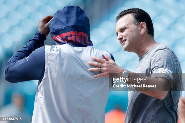 Agent Drew Rosenhaus talks with wide receiver Antonio Brown of the New England Patriots prior to the game against the Miami Dolphins at Hard Rock...