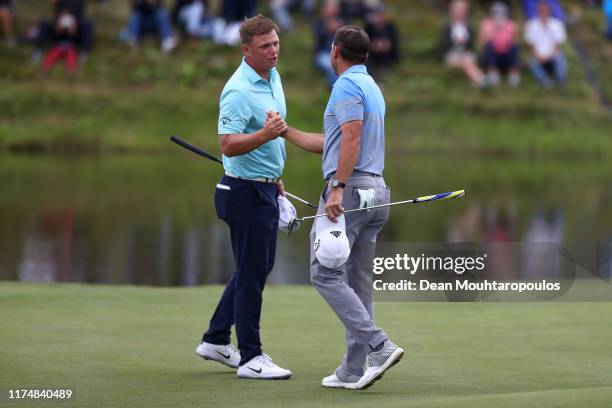 Sergio Garcia of Spain shakes hands with Callum Shinkwin of England on the eighteenth green during Day Four of the KLM Open at The International Golf...