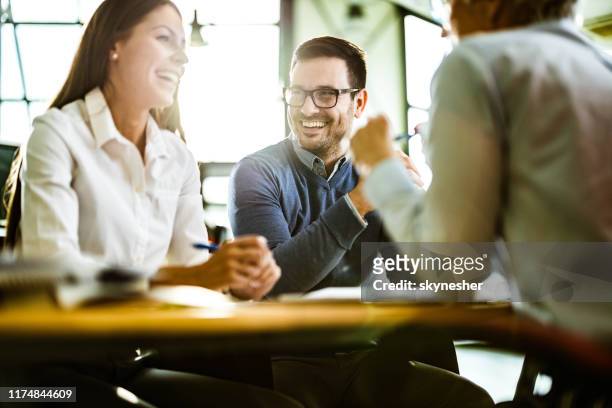 happy couple talking to their insurance agent on a meeting in the office. - happy customer stock pictures, royalty-free photos & images