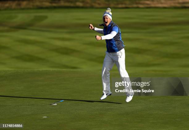 Suzann Pettersen of Team Europe celebrates making her final putt on the 18th hole as Europe wins the Solheim Cup during the final day singles matches...