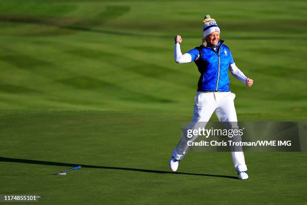 Suzann Pettersen of Team Europe celebrates her winning putt on the eighteenth hole in her match with Marina Alex of Team USA during the final day...