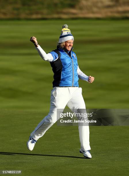 Suzann Pettersen of Team Europe celebrates making her final putt on the 18th hole as Europe wins the Solheim Cup during the final day singles matches...