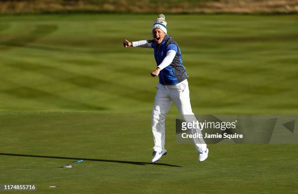 Suzann Pettersen of Team Europe celebrates making her final putt on the 18th hole as Europe wins the Solheim Cup during the final day singles matches...