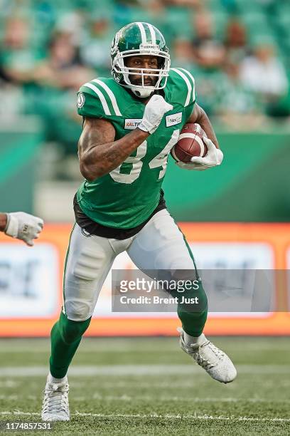 Emmanuel Arceneaux of the Saskatchewan Roughriders runs after a catch in the game between the Montreal Alouettes and the Saskatchewan Roughriders at...