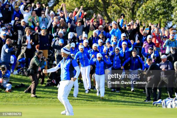 Suzann Pettersen of Team Europe celebrates her winning putt on the eighteenth hole in her match with Marina Alex of Team USA during the final day...
