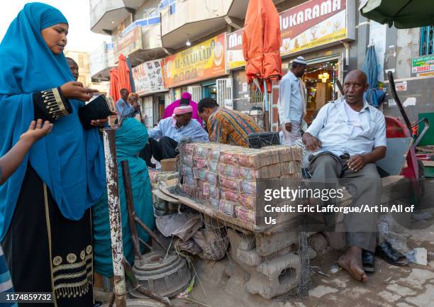 Wads of money changer on his stall "n, Woqooyi Galbeed region, Hargeisa, Somaliland on August 4, 2019 in Hargeisa, Somaliland.