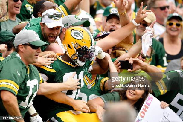 Geronimo Allison of the Green Bay Packers celebrates with fans after scoring a touchdown in the first quarter against the Minnesota Vikings at...