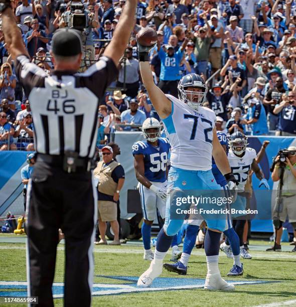 David Quessenberry of the Tennessee Titans celebrates after making a touchdown reception against the Indianapolis Colts during the first half at...