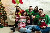 Friends In Ugly Sweater Celebrating Christmas Together At Home