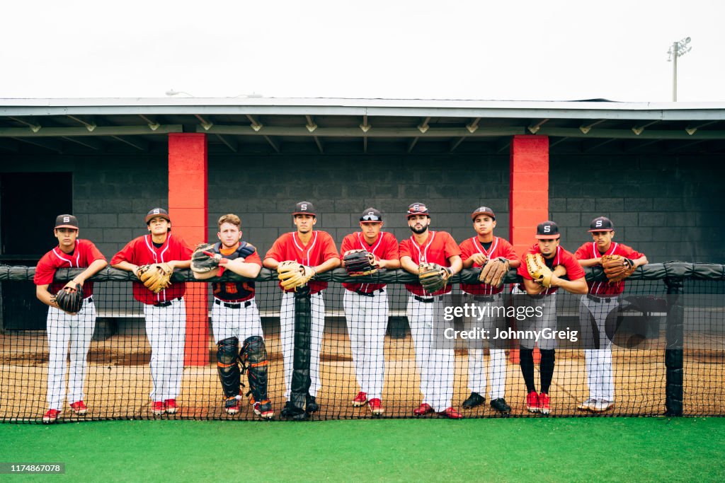 Portrait of Hispanic nine-man baseball team lined up to play