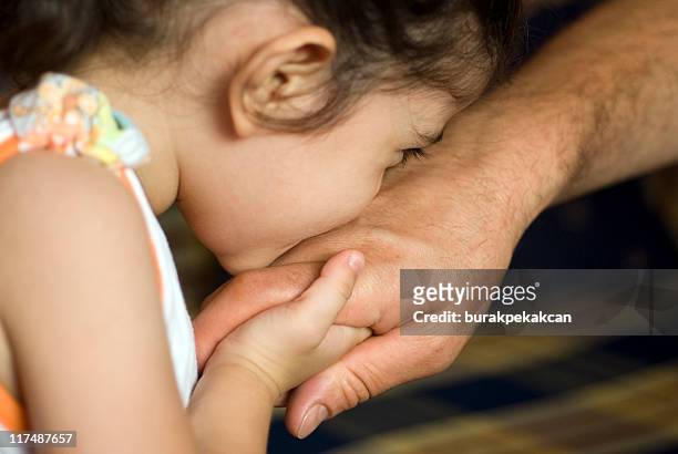 girl kissing father's hand, close-up, turkey, istanbul - kissing hand stock pictures, royalty-free photos & images