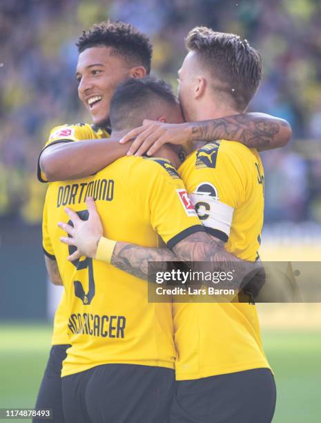 Marco Reus of Dortmund ceelebrates with Jadon Sancho of Dortmund and Paco Alcacer of Dortmund during the Bundesliga match between Borussia Dortmund...