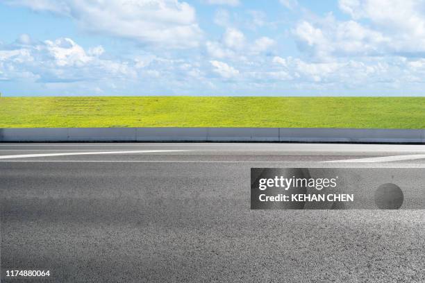 empty road with clear blue sky and grass ground - empty road stock pictures, royalty-free photos & images
