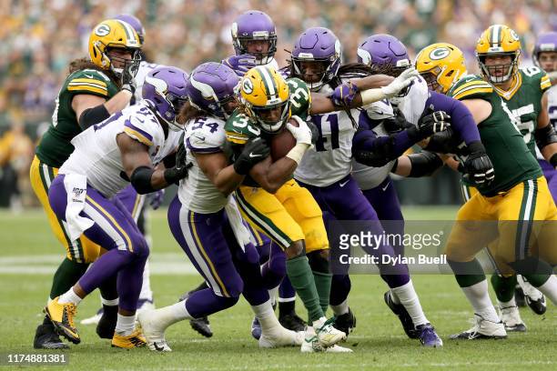 Aaron Jones of the Green Bay Packers runs with the ball against Eric Kendricks of the Minnesota Vikings in the fourth quarter at Lambeau Field on...