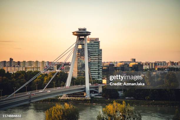 view of a bridge and cityscape in bratislava - bratislava slovakia stock pictures, royalty-free photos & images