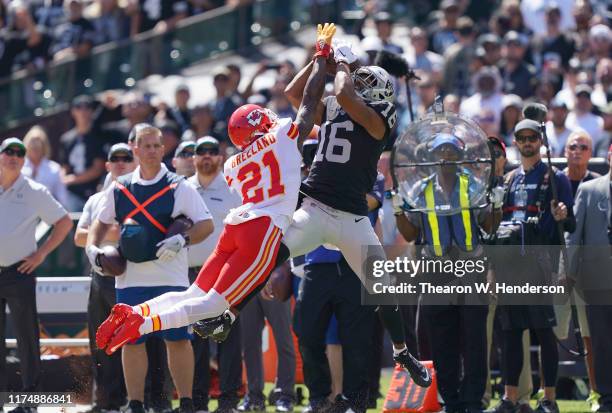 Tyrell Williams of the Oakland Raiders catches a pass over Bashaud Breeland of the Kansas City Chiefs during the first quarter of an NFL football...