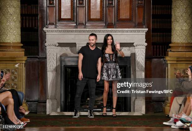 Designers Kristian Aadnevik and Hila Biton-Aadnevik on the runway after the AADNEVIK show during London Fashion Week September 2019 at The Royal...