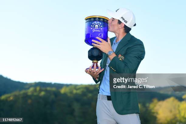 Joaquin Niemann of Chile poses with the trophy after winning A Military Tribute At The Greenbrier held at the Old White TPC course on September 15,...