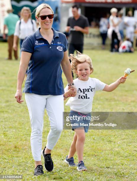 Zara Tindall walks hand in hand with daughter Mia Tindall as they attend day 3 of the Whatley Manor Gatcombe International Horse Trials at Gatcombe...