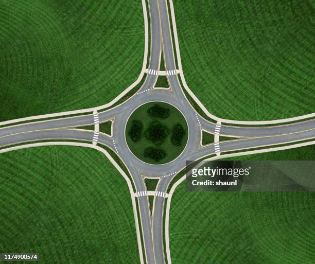 roundabout symmetry - road intersection stock pictures, royalty-free photos & images
