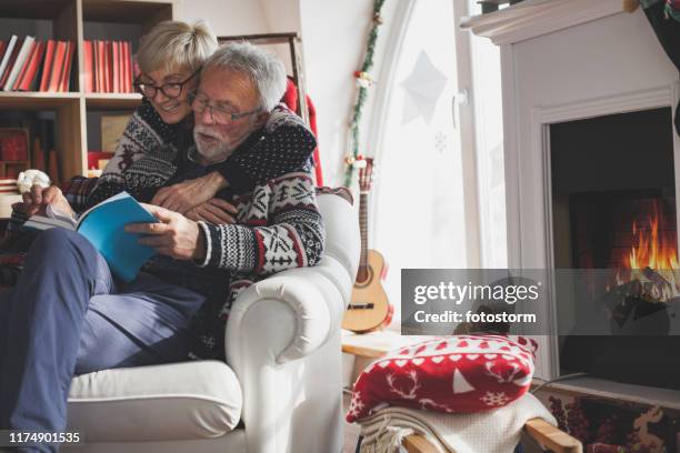 cozy winter's day and a good book - christmas elderly stock pictures, royalty-free photos & images