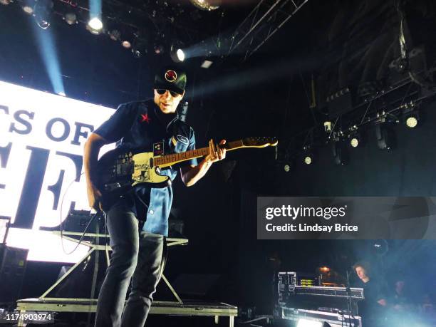 Tom Morello reattaches his guitar as he performs with Tim Commerford, Brad Wilk, B-Real, Chuck D, and DJ Lord in Prophets of Rage at The Mayan...