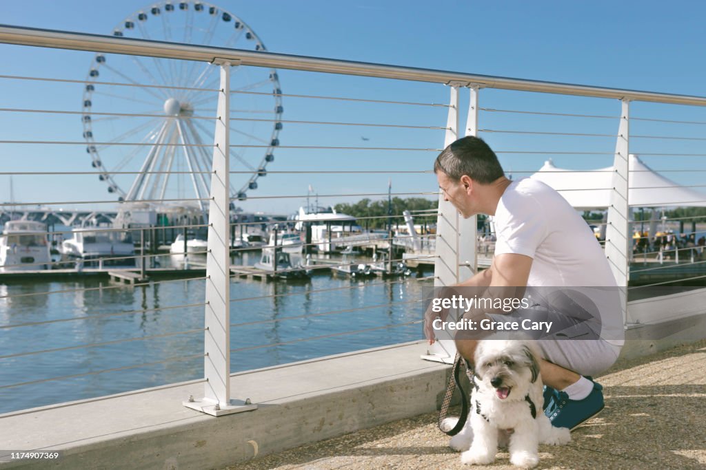 Man and Dog Rest on Waterfront
